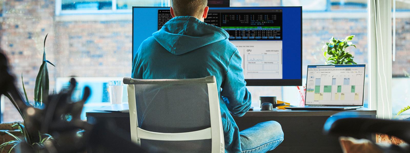 A data analyst working on a desktop computer