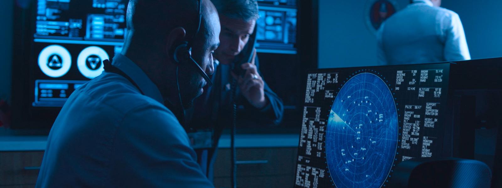 Two people looking at a monitor screen