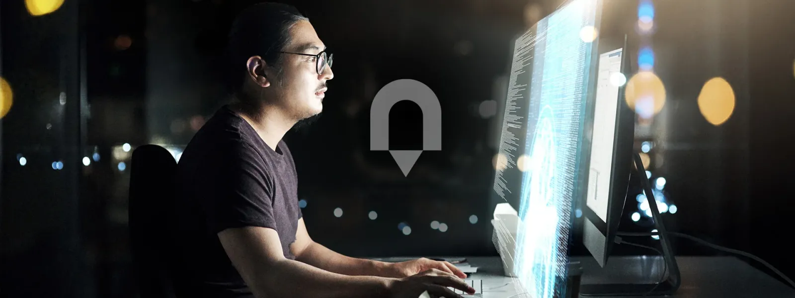 Man at computer with double screens