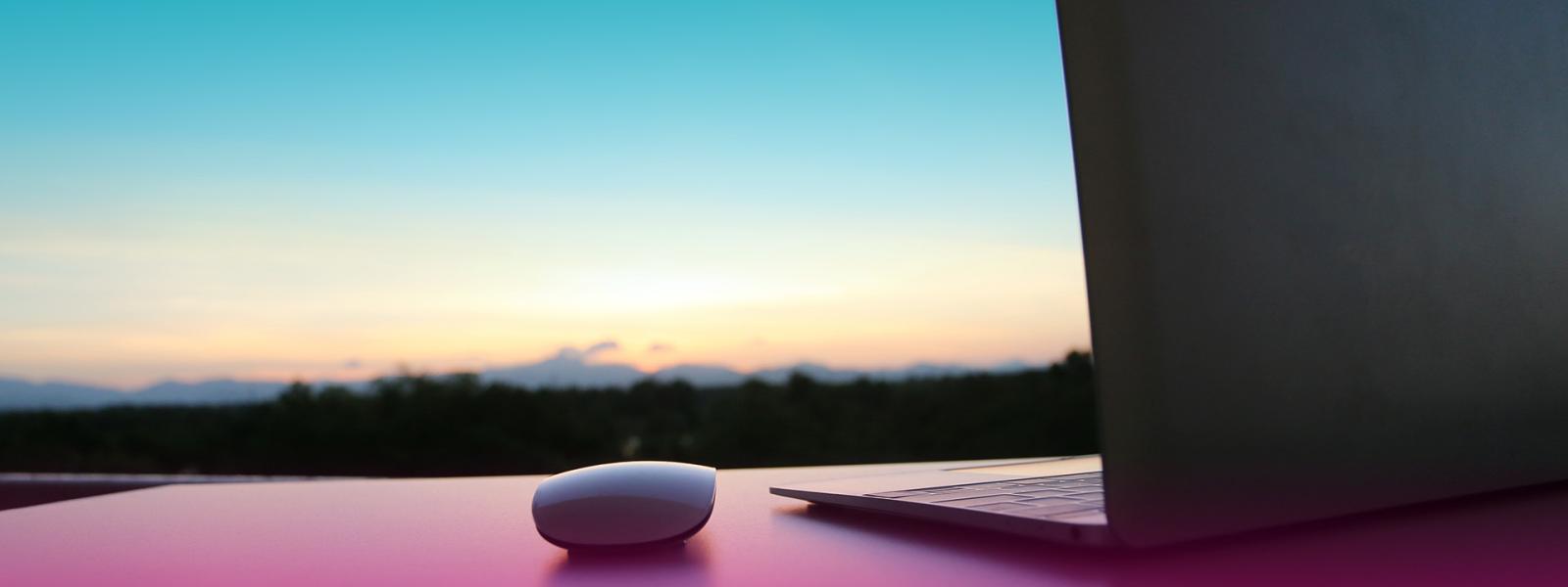 mac laptop and mouse on a desk