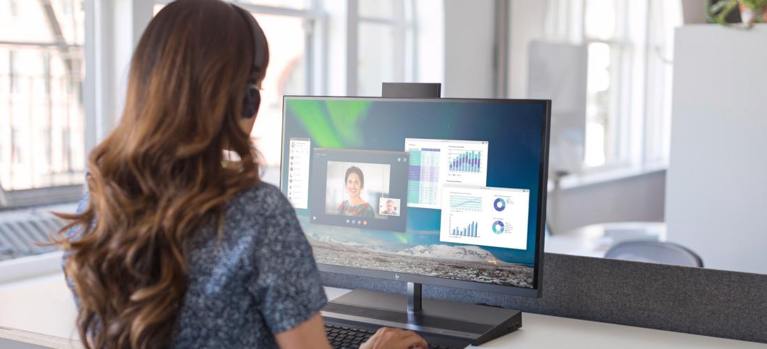 A woman working on a desktop computer