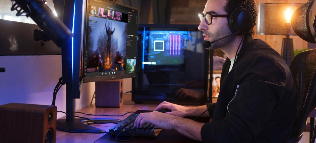 Man working at desk with multiple screens