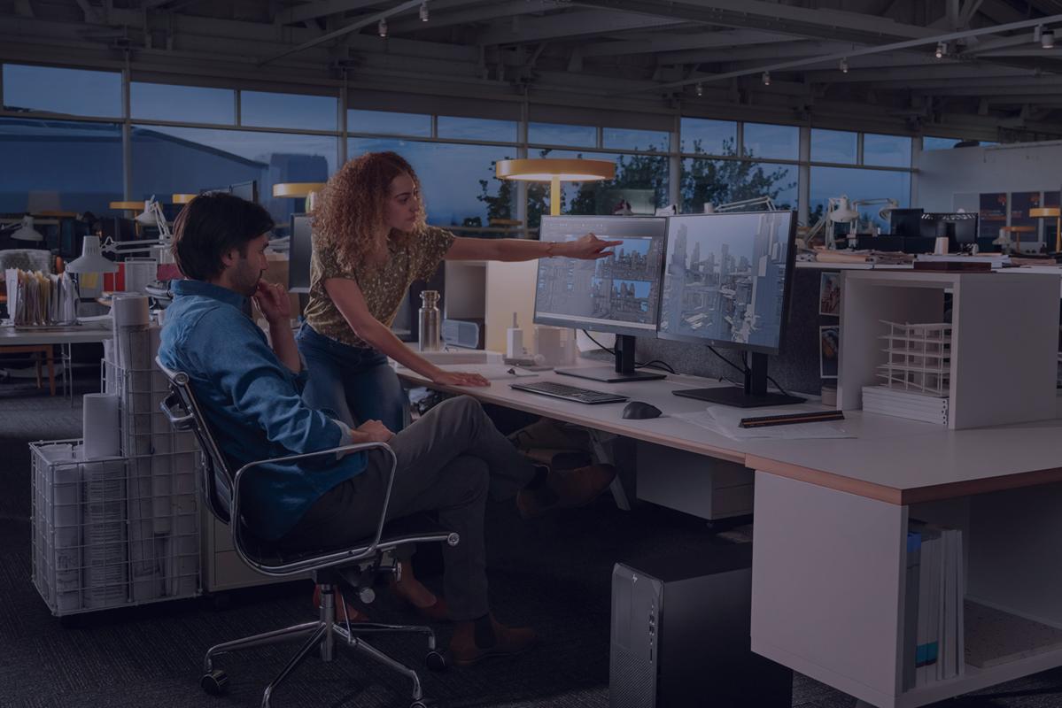 Employees collaborating at a work station